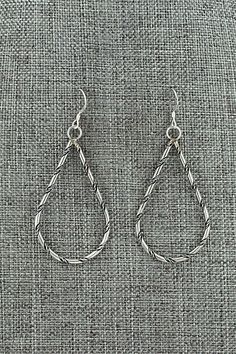 These sterling silver earrings were made by Navajo silversmith Nashina Leonard.Length: 2 1/4"Width: 1"Free shipping on all orders! We ship with USPS and always include tracking. All orders ship within a day of payment.Returns are accepted up to 30 days after you receive your order. Just send us a message. Our shop offers cash back or store credit. The item must be returned in new condition. Southwestern Style Sterling Silver Drop Earrings, Bohemian Sterling Silver Hand-wrapped Earrings, Nickel-free Southwestern Hoop Earrings, Vintage Navajo Earrings, Southwestern Turquoise Nickel-free Hoop Earrings, Instagram Jewelry, Bear Carving, White Buffalo, Pearl Chain