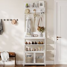 a white shelf with shoes and umbrellas on it next to a wooden bench in front of a door