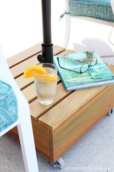 an orange slice is sitting on top of a table next to a book and glasses