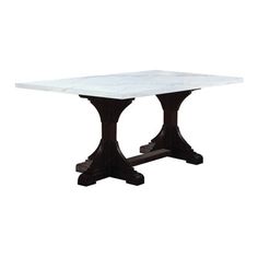 a white marble dining table with two black pedestals on each side and an intricately carved base