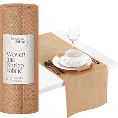 a roll of burlap next to a place setting