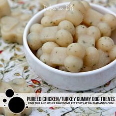 a white bowl filled with cooked chicken / turkey gummy dog treats on a floral tablecloth