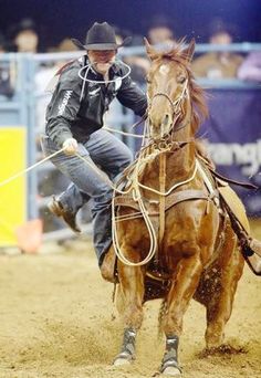 a man riding on the back of a brown horse