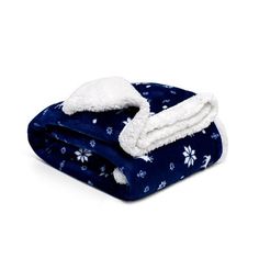 a blue blanket with white snowflakes on it and two blankets folded in the same direction