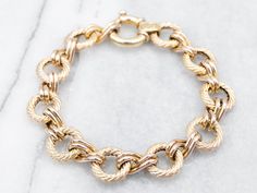 "This sophisticated bracelet offers a timeless style perfect for any occasion. Crafted with a luxurious yellow gold, it secures with a chunky spring ring clasp for a comfortable fit. Metal: 14K Yellow Gold Width: 12.9 mm Length: 7 3/4 Inches Marks: \"585 14KITALY\" Stamped on the clasp To view a video of this piece check out the link below: https://vimeo.com/831655879 SKU #: A27305 Each piece has been identified and graded by a Graduate Gemologist who has been certified by the Gemological Institute of America (GIA). We have six brick-and-mortar storefronts in Maine, Massachusetts, and New Hampshire and have been in business for over 25 years! Please visit our Shop's About Page or our website for more information about our jewelry. For questions about diamond grading, we recommend the Gemol Bracelet Layering, Rope Ring, Rope Rings, Spring Bracelet, Fine Silver Jewelry, Yellow Gold Bracelet, Layered Bracelets, Pearl Pendant, Chain Link Bracelet