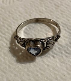 This little ring is so tiny and delicate that my camera couldn't capture all the detail. I believe it is Native American made.  It is marked 925 inside. It fits my pinky perfectly so it should measure in as a size 6. I got this ring in an estate group of jewelry. I can only guess at its age.  It belonged to a woman about 80 years of age so she may have owned it since maybe the 1960's-80's somewhere.  Free shipping in the US. Delicate Heart-shaped Silver Rings, Silver Heart-shaped Birthstone Ring With Gemstone, Silver Heart-shaped Birthstone Ring, Vintage Sterling Silver Topaz Promise Ring, Vintage Silver Crystal Ring With Birthstone, Silver Heart Cut Ring With Birthstone, Vintage Heart Cut Birthstone Heart Ring, Vintage Heart Cut Birthstone Ring, Vintage Sterling Silver Heart Shaped Ring