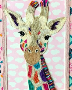 a close up of a giraffe on a pink background