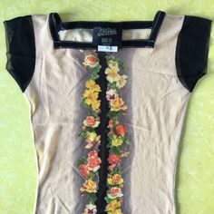 Fantastic 1990s Jean Paul Gaultier mesh floral tattoo top. Flowers decorate the center front and hem. Flowers are roses and pansies. Square neckline. Fabric is the classic sheer nylon stretch mesh that Gaultier loves to use. Label Jean Paul Gaultier, Maille, Femme. Size M. 100% Nylon. Please hand wash cool, drip dry. Very good vintage condition with no fabric or sewing flaws. Measurements - Very stretchy. Measurements given without stretch Shoulders 44cm/ 17inches Chest 74cm/ 29inches Waist 60cm Fitted Floral Print Mesh Top For Summer, Stretch Shoulders, 90s Jean, Top Flowers, 90s Jeans, Club Kids, Cute Butterfly, Drip Dry, Paul Gaultier