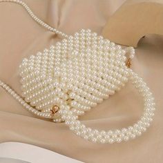 Why You'll Love It: Add a luxurious element to your style with this versatile faux pearl bag. The handmade craftsmanship guarantees a unique, high-quality accessory that is perfect for adding elegance to your everyday looks or standing out at special occasions. Key Features: *Material: High-quality faux pearls woven into a durable, elegant structure. *Versatile Style: Great for everyday use, weddings, parties, or adding a touch of elegance to any occasion. *Compact Size: Fits your essentials comfortably -- Dimensions: Height 19cm (7.48 inches), Length 15cm (5.91 inches), Width 7.5cm (2.95 inches). *Functional Design: Comes with a convenient handle and a long shoulder strap, giving you the option to carry it as a handbag or wear it as a crossbody. *Color: Available in a delicate pearl white Elegant Cream Bag, Elegant Cream Bags, Elegant White Mobile Phone Bag, Luxury Pearl Bag As Gift, Cream Bags With Pearl Handle, Fashion Cream Bag With Pearl Handle, Cream Crossbody Bag With Pearl Handle, Cream Crossbody Shoulder Bag With Pearl Handle, Cream Rectangular Shoulder Bag With Pearl Handle