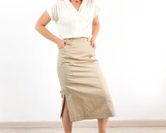 Amazing vintage high waist midi pencil skirt in tan beige. This vintage minimalist midi skirt has waist with belt loops and back button and zip closure, side splits and pockets. The 80's wiggle pencil skirt is cotton and polyester fabric with inner lining in excellent vintage conditions by Mode Weiss. The size skirt is Small, the waist contour fit is 25,1 inches (64 cm). ** MEASURES FLAT ** Waist 12,5 in // 32 cm Hip 19,3 in // 49 cm Length 30,7 in // 78 cm Reference: Model size S (4 US - height Cotton Fitted Midi Pencil Skirt, Cotton Midi Pencil Skirt, Beige Fitted Midi Length Pencil Skirt, Fitted Beige Midi Length Pencil Skirt, Summer Fitted Beige Pencil Skirt, Fitted Beige Pencil Skirt For Summer, High Waist Lined Beige Pencil Skirt, High Waist Beige Lined Pencil Skirt, High Waist Beige Pencil Skirt With Lining