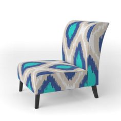 an upholstered chair with blue and white designs on the back, sitting in front of a white background