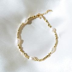 "Our Saylor Pearl Bracelet is absolutely eye-catching! What do we love about it? The stunning gold beads mixed with the natural pearls make for a beautiful piece to stack with your other bracelets. --------------------- FEATURES ◊ Genuine baroque freshwater pearl (5-6mm x 7mm) ◊ Yellow Gold, Rose Gold or Silver Plated Hex Spacer Beads ◊ 100% Gold-filled or Sterling Silver extender chain and findings (clasp/jump rings) to ensure the highest quality piece ◊ We include a 1\" extender to add 1\" of Pearl Bracelets With Gold Beads As A Gift, Pearl Bracelets With Spacer Beads For Gifts, Adjustable Beaded Pearl Charm Bracelet, Adjustable Pearl Bracelets With Round Beads, Dainty Pearl Beaded Bracelets With Spacer Beads, Beaded Rondelle Bracelets Perfect For Gifts, Beaded Rondelle Bracelets Ideal As Gifts, Dainty Pearl Beaded Bracelet With Spacer Beads, Pearl Beaded Rosary Bracelet With Round Beads