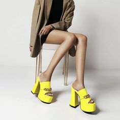 These are the ultimate 90's platforms! Rachel Platform Mules have vegan leather construction with a patent finish, chunky-heeled platform soles, and a slip-on fit, featuring a gold-tone metal chain embellishment at the front. Slip-on Man-made Materials Platform Imported Platform Mules Outfit, Mules Outfit, Platform Mules, Yellow Outfit, Platform Heels Chunky, Everything Is Fine, Chunky Platform, Chunky Heel, Platform Shoes