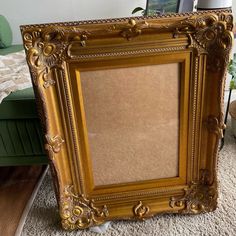 an old gold frame sitting on the floor