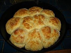 a skillet filled with bread sitting on top of a table