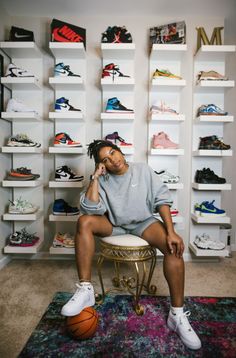 a man sitting on top of a stool next to a basketball