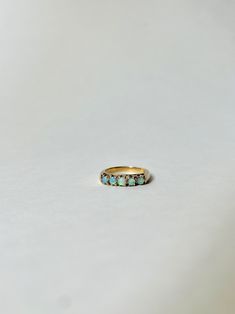 Vintage 14k Gold and Australian Opal Band Ring. This vintage band ring is made with 14k gold and contains 5 cabochon Opals. Marked 14k, S inside of a Diamond. Most likely made between the 1920's-1940's. SIZE: 6 3/4 OVERALL CONDITION: Minor scuffs on the band but overall beautiful condition. GEMSTONES: 5 Australian Opals Vintage Opal Ring, Opal Band Ring, Opal Ring Vintage, Metal Smithing, Opal Band, Vintage Band, Opal Ring, Australian Opal, Ring Vintage