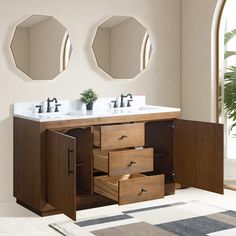 a bathroom vanity with two mirrors above it