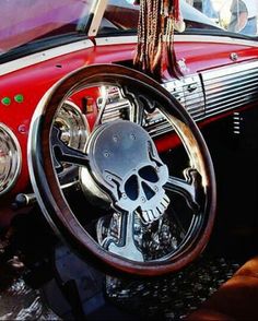 the interior of an old car with a skull steering wheel