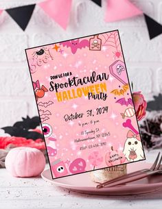 a pink halloween party poster on a table with other decorations and decor items around it