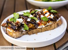 a white plate topped with food on top of a wooden table