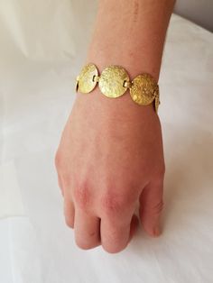 This luxurious Hammered Gold Disc Bracelet is made out of Solid 18K Gold with 3 small diamonds set in each disc. This is truly a statement of elegance and luxury. A special one of a kind piece of jewellery for a special one of a kind women. Handcrafted by an expert goldsmith and gemmologist this bracelet has an ancient feel to it, full of personality, mystery and depth. A gorgeous bracelet to compliment a beautiful women. Details: Material: Solid 18k yellow Gold Weigth: 33-35 Width: 20mm[link di Textured Bracelet, Beautiful Wedding Bands, Disc Bracelet, 18k Gold Bracelet, Gold Armband, Gold Disc, Gold Engraving, Hammered Gold, Engraved Jewelry