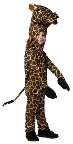 a child in a giraffe costume standing on one leg and holding an animal's tail