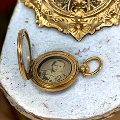 Step back in time with this exquisite late Victorian or early Edwardian gold-filled mourning locket pendant. 🕰️🌹 This treasured piece encases a sepia picture of a little boy behind a glass window, preserving a poignant memory from the past. Open it to reveal the picture protected by another round glass frame. 📸✨  The picture is not straight but is placed sideways in the locket so the person wearing it on a chain can easily take it in her hand and look at the little boy.  Though unsigned, this Victorian Jewelry With Coin Pendant, Antique Medallion Jewelry With Historical Design, Antique Medallion Jewelry For Commemoration, Vintage Gold Jewelry For Commemoration, Antique Commemoration Medallion Jewelry, Vintage Yellow Gold Necklace For Commemoration, Antique Gold Jewelry For Commemoration, Victorian Medallion Jewelry With Historical Design, Antique Bronze Jewelry For Commemoration