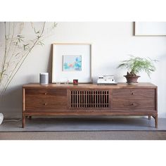 the sideboard is made from wood and has an air purifying device on top