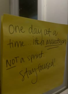 a yellow sign with writing on it that says one day at a time