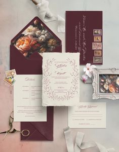 the wedding stationery is laid out on top of each other, including an envelope