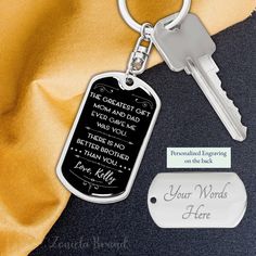 a keychain with a quote on it next to a tag and two keys