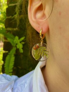 Add a touch of enchantment to your fall wardrobe with these stunning gold-filled dangle earrings made of resin, featuring real acorn, fern, and oak leaf accents. These unique pieces are the perfect accessory for the autumn season, making them an ideal gift for Thanksgiving or as a thoughtful hostess gift. Embrace your inner forest witch with these Mori Kei inspired forest jewelry pieces, which are also a wonderful gift for a teacher, daughter, friend, or girlfriend. Bring a little piece of the f Nature-inspired Resin Jewelry, Nature-inspired Dangle Hoop Earrings For Gift, Nature-inspired Dangle Hoop Earrings As Gift, Nature-inspired Dangle Hoop Earrings, Botanical Style Gold Resin Jewelry, Nature-inspired Drop Earrings With Birth Flower, Nature-inspired Birth Flower Drop Earrings, Nature-inspired Dangle Flower Earrings, Nature-inspired Gold Hoop Earrings