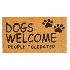 a door mat with the words dogs welcome people tolerated on it and paw prints