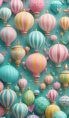 many colorful hot air balloons are hanging from the ceiling in front of a blue wall