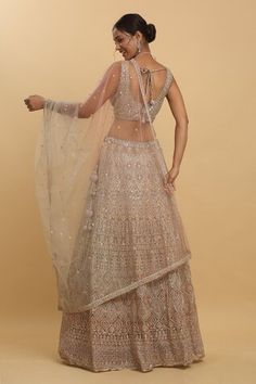 Earthy beige attached can-can lehenga featuring thread and mirror embroidery all over. Paired with a co-ordinating padded blouse and a sheer embroidered dupatta. - Aza Fashions Beige Sets With Mirror Work For Reception, Festive Anarkali Beige Choli, Festive Beige Lehenga With Zari Work, Beige Choli With Dupatta For Festive Occasions, Festive Beige Choli With Sheer Dupatta, Beige Choli For Diwali And Festive Occasions, Beige Choli For Festive Occasions Like Diwali, Festive Beige Choli With Dupatta, Party Beige Choli With Dupatta