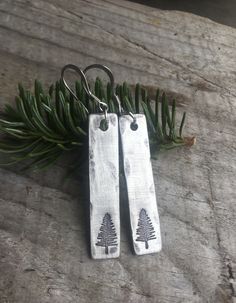 "Evergreen Earrings / Nature Jewelry / Pine Tree Earrings / Nature Lover Gift / Outdoorsy Gifts / Adventure Jewelry / Bridesmaid Gift The perfect, understated gift for nature lovers, gardeners, hikers, or a wonderful gift to present to anyone who helps you Stand Strong. Each piece is stamped by hand, so your piece may have slight variations from the photo. You'll receive 1 set of earrings, handmade in Pewter, hammered and lightly distressed. Choose the size that works for you: -Shorter Earrings Personalized Dangle Earrings For Gifts, Hand Stamped Sterling Silver Earrings For Gift, Sterling Silver Hand Stamped Earrings For Gifts, Personalized Silver Earrings As Gift, Nature-inspired Hammered Earrings As Gift, Hypoallergenic Nature-inspired Earrings As Gift, Nickel-free Nature-inspired Earrings For Gift, Hypoallergenic Nature-inspired Earrings For Gifts, Nickel-free Nature-inspired Earrings As Gift