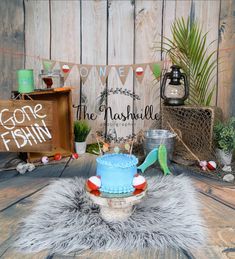 a blue cake sitting on top of a wooden table