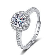 a white gold ring with diamonds on the side and a center stone in the middle