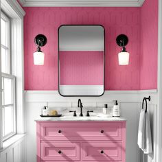 a bathroom with pink and white walls, two sinks and a large mirror on the wall