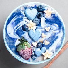 a bowl filled with blueberries, strawberries and stars