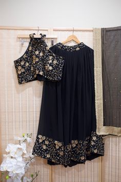 *Ready made 3 piece set  *Black & gold Floral Embroidered Halter Blouse, Flared skirt with matching border, and net dupatta  *Color may vary slightly from picture  *Our store is located in Los Angeles & in store pick up is welcome. Semi-stitched Georgette Sets With Zari Work, Semi-stitched Sets With Gold Embroidery And Traditional Drape, Festive Sharara With Gold Embroidery, Embroidered Chinon Sets For Reception, Reception Embroidered Chinon Sets, Unstitched Sharara With Gold Embroidery For Festive Occasions, Festive Sharara With Gold Embroidery In Chinon, Unstitched Festive Sharara With Gold Embroidery, Unstitched Gold Embroidery Sharara For Festive Occasions