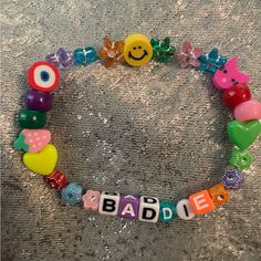 a bracelet with beads and letters that spell out the word badie