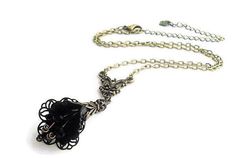 Absolutely gorgeous Victorian-style inspired hand-painted black orchid choker necklace. Romantic statement accessory for any occasion to compliment any outfit. This botanical flower pendant necklace is created with hand-dyed ruffled Lucite orchid flowers embellished with fancy antique brass filigree wraps and adorned with layers of antique brass leaf caps topped with sparkling small black glass crystal beads. Three black crystal beads dangle inside each flower imitating the flower stem. The pend Elegant Black Flower Necklace For Party, Elegant Black Flower Pendant Necklace, Elegant Metal Flower Necklace For Party, Black Flower Necklace For Party, Delicate Black Necklace For Gift, Black Adjustable Flower Pendant Necklace, Adjustable Black Flower Pendant Necklace, Elegant Black Flower Necklaces, Handmade Black Flower Necklace