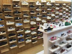 there are many pairs of shoes on display in the store's shoe rack area