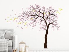 a living room wall with a tree and butterflies on it