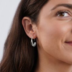 These earrings were designed to add a unique twist to the must-have gold hoop trend. Classic, timeless, and guaranteed to elevate any look. Silver plated Size: 1in x 0.8in Holds safely in the ear Lightweight Hypoallergenic, lead & nickel free If you aren't in LOVE with your purchase, please let us know within 30 days of receiving your item, and you'll receive a stress-free refund. Chunky Silver Hoop Earrings, Wide Silver Ring, Chunky Silver Rings, Drop Hoop Earrings, Liquid Metal, Silver Ring Set, Gold Ring Sets, Gold Hoop, Silver Hoops