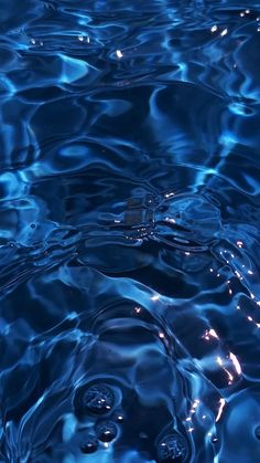 blue water with ripples and bubbles in it