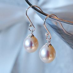 Simple, pretty and easy to wear, these pearl drop earrings go with just about everything. Made with sterling silver and genuine freshwater pearls, they would be a lovely 'something new' for your wedding day or as a thank you gift to your bridesmaids. They're also a popular present for a mother, sister or friend - to celebrate an anniverary, birthday or special occasion. Your order will arrive gift-wrapped in tissue in a Carriage Trade gift box free of charge. Pearl drops measure approximately 9mm in length. Elegant Sterling Silver Nickel-free Pearl Earrings, Elegant Sterling Silver Pearl Earrings Nickel Free, Classic Dangle Pearl Earrings, Classic Teardrop Nickel-free Pearl Earrings, Elegant Nickel-free Dangle Pearl Earrings, Classic Teardrop Pearl Earrings With Pearl Pendant, Elegant Nickel-free Pearl Earrings, Elegant Hypoallergenic Pearl Earrings In Sterling Silver, Elegant Hypoallergenic Sterling Silver Pearl Earrings