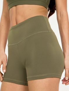 elasticized waist hidden back pocket go-dry wicks moisture sits at belly button fitted hip and thigh hits high on thigh 4" inseam models are approx.  5'9" and wear sizes s (4), l (12), and xl (18)machine wash according to the care instruction label Sports Bottoms With Contoured Waistband And 5-inch Inseam, Basic Activewear With Built-in Shorts, Solid Moisture-wicking Bottoms With 5-inch Inseam, Basic Stretch Bottoms With Built-in Shorts, Fitted Biker Shorts With 5-inch Inseam For Gym, Fitted Training Bottoms With Built-in Shorts, Fitted Bottoms With Built-in Shorts For Workout, Compressive Moisture-wicking Biker Shorts With 5-inch Inseam, Athleisure Shorts With Contoured Waistband